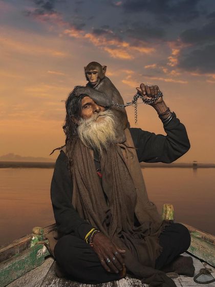 A recreation of the famous Monkey Baba portrait, this time with a beautiful sunset over the Ganga. The warm colors add a painterly quality to this story of human-animal companionship.