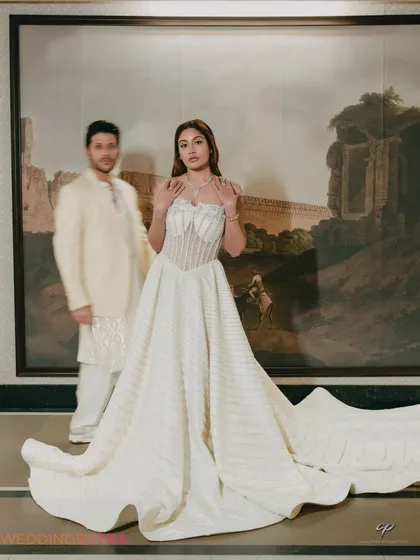 An artistic portrait using a shallow depth of field to create a dreamy, romantic effect. The bride is in sharp focus while the groom is a soft presence, adding a creative touch to the image.