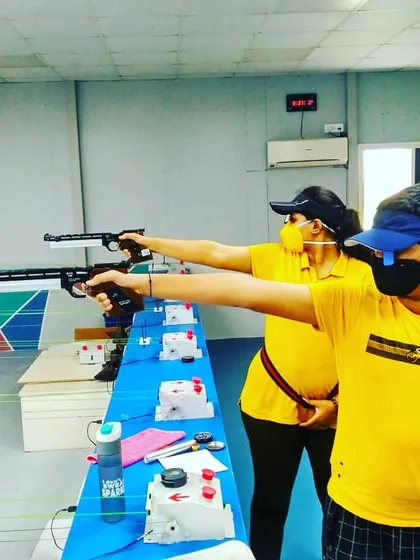 Campers also get hands-on experience with air pistols. These young shooters are learning the distinct techniques of pistol shooting, focusing on grip and arm stability.
