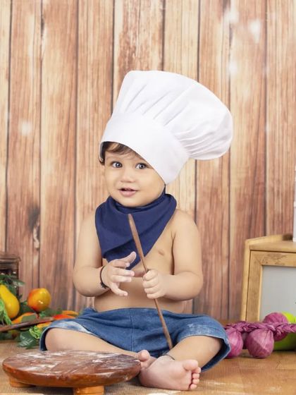 This little chef is taking his job very seriously, ready to whip up a delicious meal.