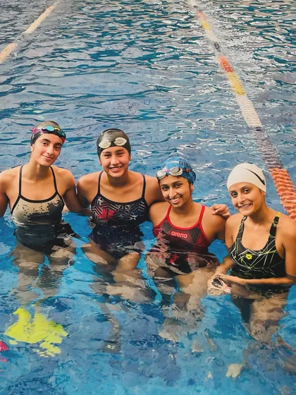 Anshi Aggarwal (in red Arena suit) with her training partners. The supportive and competitive environment we foster helps our swimmers achieve their goals, both in and out of the pool.