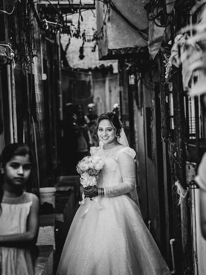 The bride walking through the alley, her smile contrasting with the gritty, real environment. A perfect example of my documentary wedding photography style.