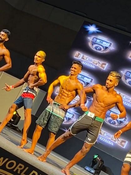 A lineup from the ICN natural bodybuilding championship. My client is hitting a pose with confidence, showcasing the physique we built in just 10 weeks.