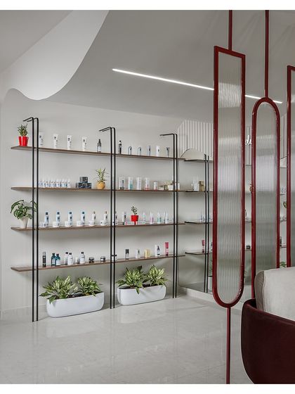 The retail display area features minimalist black metal and wood shelves. This clean and organized design allows the products to be the heroes, while integrated planters add a touch of green.