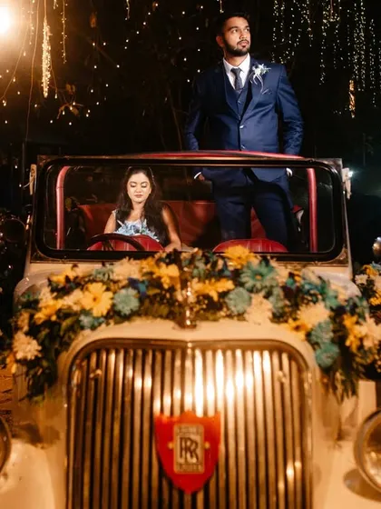 A classic portrait with a vintage car, but with a creative twist. The composition gives the shot a cinematic, story-driven feel, like a scene from a classic film.
