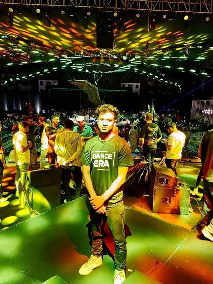 Standing on the stage is where I feel most at home. This photo was taken at a large-scale dance event, and this is the environment of energy and professionalism I bring to your events.