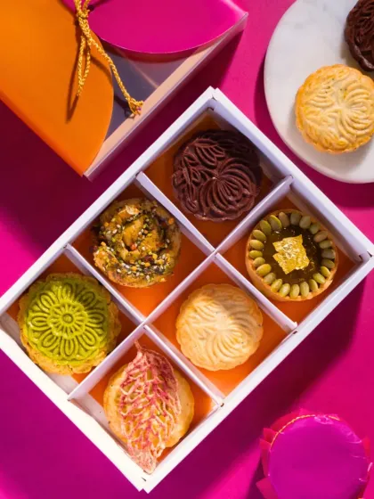 A glimpse inside one of my modern festive gift boxes. Each compartment holds a unique creation, from gold-dusted pumpkin fudge tartlets to intricately molded chocolate biskuts, offering a journey of reinvented Indian flavors.