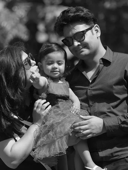 A classic black and white family portrait taken outdoors, showcasing a timeless and emotional feel.