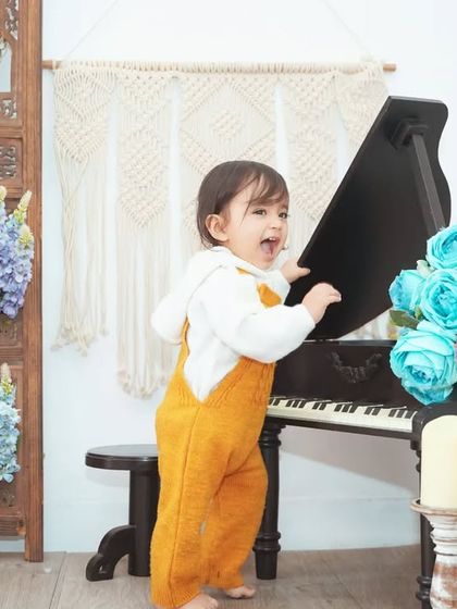 A wide shot showing our versatile studio setup with a boho screen, mini piano, and floral accents.