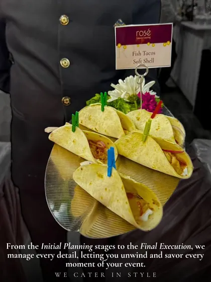 A server presents a tray of soft-shell Fish Tacos. From initial planning to final execution, we manage every detail of your event, allowing you to relax and savor every moment in style.