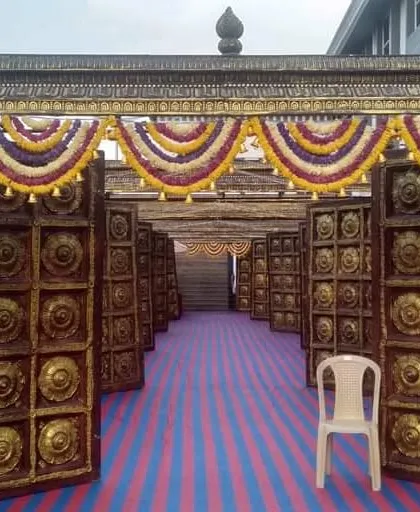 This is a grand entrance we designed for a major event. We build these impressive, traditional-style gateways with detailed carvings and flower arrangements to welcome guests.