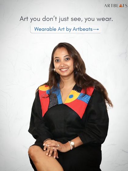 Art you don't just see, you wear. Here I am in one of my own designs, a black dress with a colorful, abstract art collar that truly embodies the spirit of wearable art.