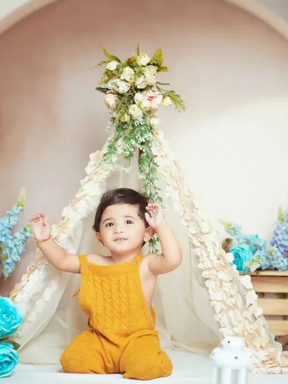 A sweet baby boy in our boho teepee setup. The neutral tones, pampas grass, and blue flowers create a calm and dreamy atmosphere.