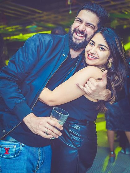 A couple having a fun moment at the party.