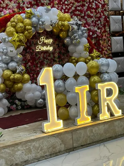 Another angle of the 'IRA' first birthday stage, showing the impressive scale of the marquee letters.