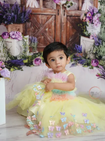 This enchanting garden-themed shoot features a beautiful yellow butterfly dress and a backdrop of rustic doors and lavender flowers.