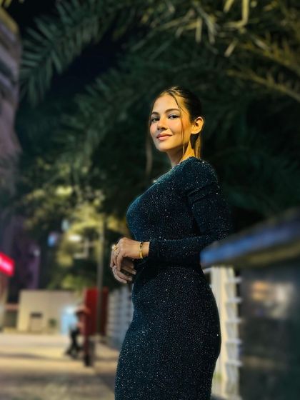 A confident pose from a client who feels amazing in her professionally styled hair and makeup.