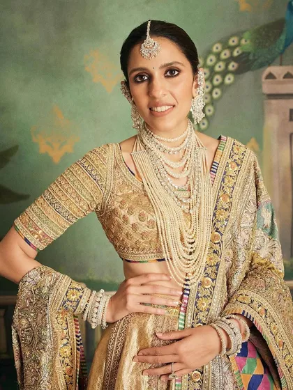 A close-up of the stunning pearl and polki jewelry complementing this royal Abu Jani Sandeep Khosla lehenga. The entire look is a masterclass in heritage styling.