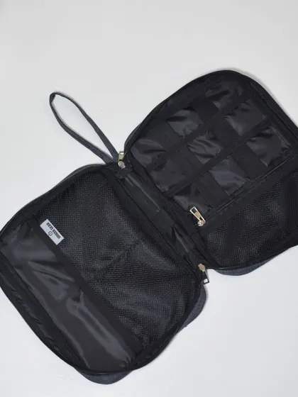 This spacious tech pouch offers multiple mesh pockets and compartments to keep all your gadgets and accessories organized.