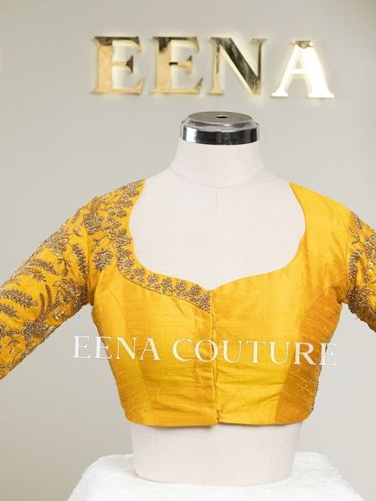 This sunshine yellow raw silk blouse is brought to life with meticulous hand embroidery by my talented artisans. The dense, traditional motifs in antique gold threadwork cover the back and sleeves, creating a piece that radiates warmth and luxury.