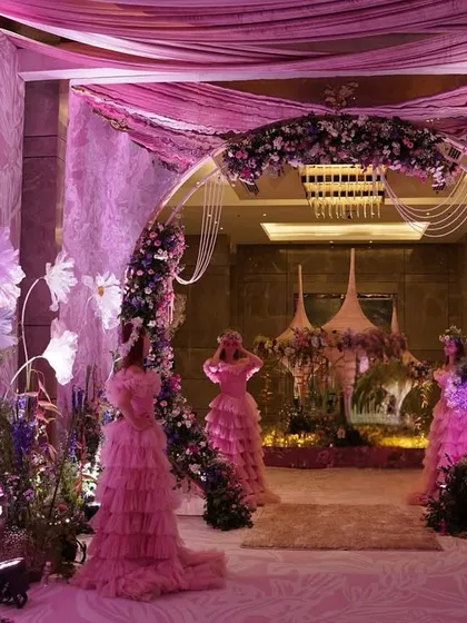An entrance designed to feel like walking through a dream. I crafted this immersive floral tunnel with oversized paper flowers, soft drapes, and ethereal lighting to set a whimsical tone for the ring ceremony.