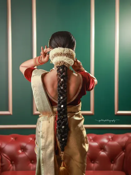 The back of a bride is just as important as the front. This shot highlights the intricate details of a traditional South Indian bridal braid, adorned with flowers and jewels.