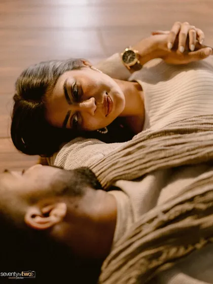 A moment of quiet connection from a unique perspective. As they lie on the floor, her gaze holds a world of love and trust. This is intimacy captured from an unexpected angle.