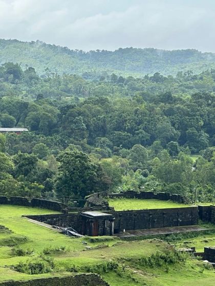 The sprawling ruins of Nagara Fort, covered in lush green grass during the monsoon.