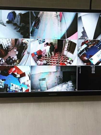 A 9-camera split-screen view monitoring different rooms and areas within a property.