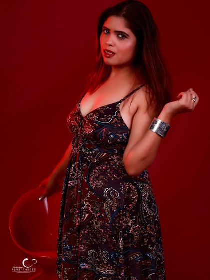 A playful and confident pose with a stool. The composition is dynamic and full of energy.