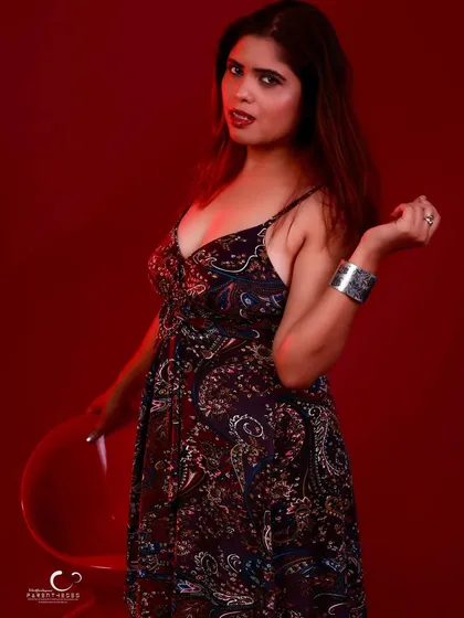 A playful and confident pose with a stool. The composition is dynamic and full of energy.