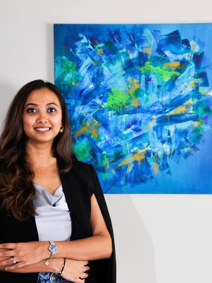 Standing with one of my favorite creations, a piece full of movement and life. The vibrant blues and energetic greens in this abstract work are a signature of my style. I am so grateful for everyone who connects with my art.
