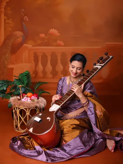 We love incorporating personal elements into our shoots. Here, the mom-to-be, a musician, holds a sitar, beautifully blending her passion with her cultural heritage.