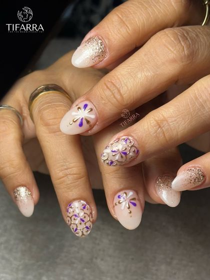 Every bloom is hand-drawn. This intricate design features purple and white floral patterns outlined in raised gold chrome for a stunning mosaic effect.