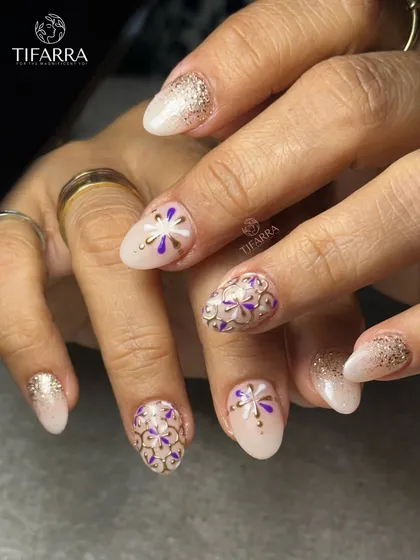 Every bloom is hand-drawn. This intricate design features purple and white floral patterns outlined in raised gold chrome for a stunning mosaic effect.