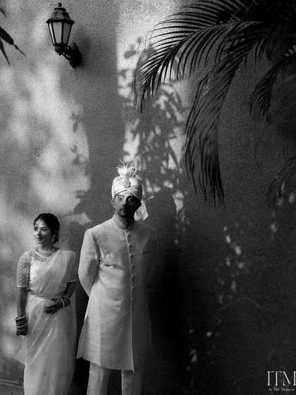 A classic black and white portrait using shadows and light for a dramatic effect. This shot feels timeless and artistic, capturing the couple in a moment of quiet elegance.