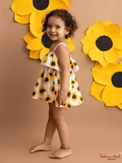 A sweet, smiling portrait of our sunflower girl. Her joy is absolutely infectious!