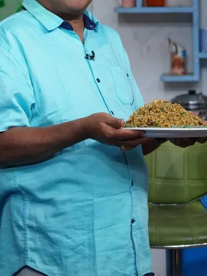 We believe presentation is just as important as taste. Here, one of our team members proudly holds a plate of freshly prepared rice, ready to be served to guests.