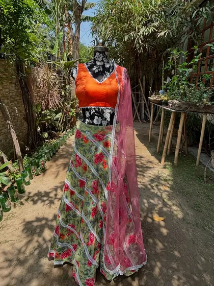 The full view of the floral mehendi lehenga. The pink net dupatta adds another layer of color and fun.