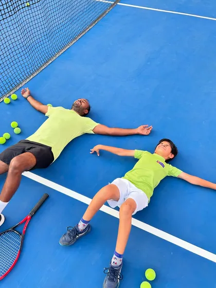Another shot of a well-deserved break on the court. Fun and hard work go hand in hand at our academy.