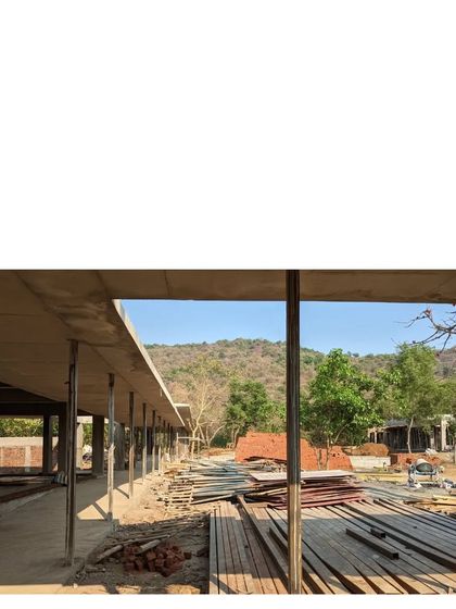 The Alibaug family commune under construction. You can see the long, one-room-thick plan taking shape, designed to maximize cross-ventilation and views of the hill.