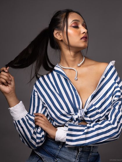 A color version of the model in a striped shirt, showing a relaxed and confident pose.