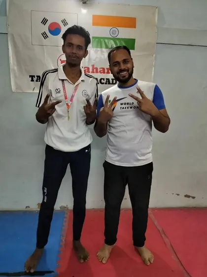 Victory signs with one of our senior fighters after his win at the district level.