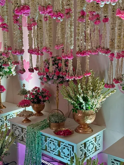 More views of the magical entrance, highlighting the density of the floral ceiling, the elegant decor pieces, and the soft, inviting lighting.
