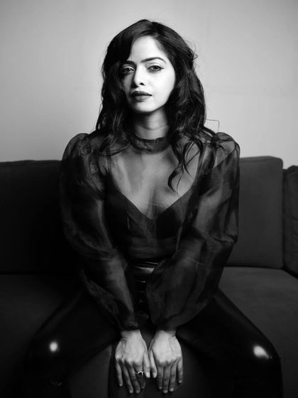 A seated, centered portrait from the B&W series. The direct, symmetrical composition gives this shot a strong, confident, and confrontational feel.