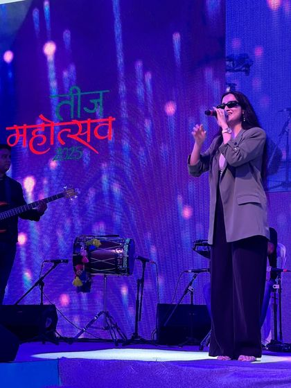 On stage with my band at the Teej Mahotsav 2025. This image shows our typical stage setup with a guitarist and dholak player, ready to deliver a mix of folk and Bollywood music.