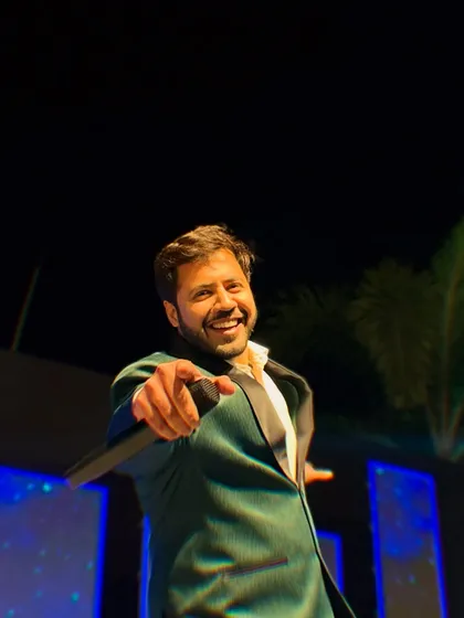On stage, in my element, and pointing right at you. I see you, and I'm ready to make you the star of your own celebration. Let's do this!