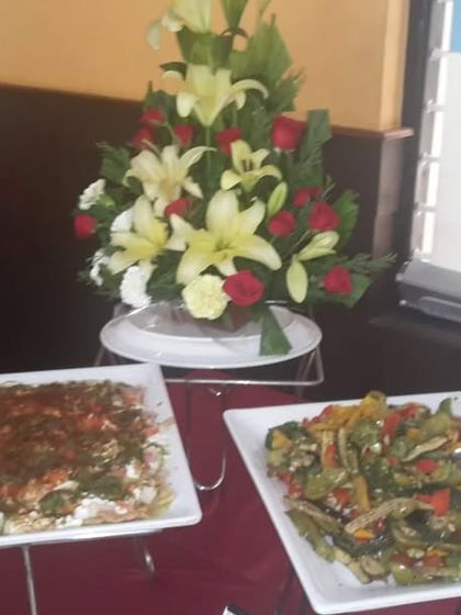 A display of fresh appetizers, including a colorful mixed vegetable platter and Dahi Bhalla. We offer a variety of light and flavorful starters for any occasion.