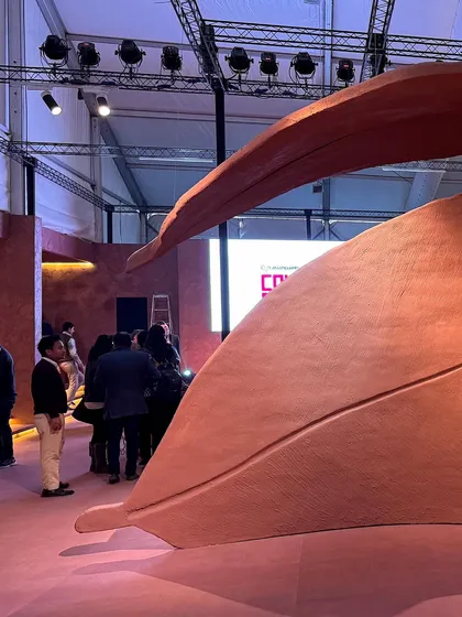 Visitors interacting with the 'Terra' installation. The scale of the piece is designed to make people feel small, fostering a sense of awe and connection to the natural world.