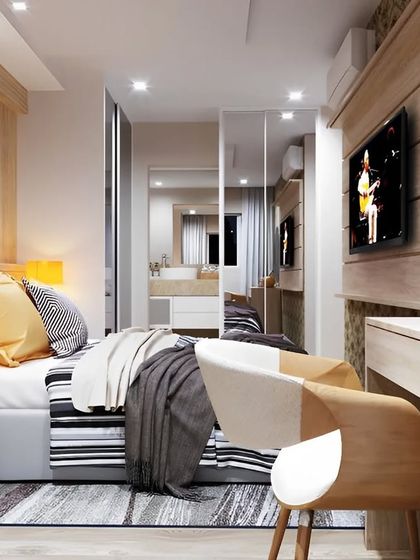 We use mirrors strategically to make small bedrooms feel larger. This room features mirrored wardrobe doors that reflect light and create an illusion of depth, enhancing the sense of space.